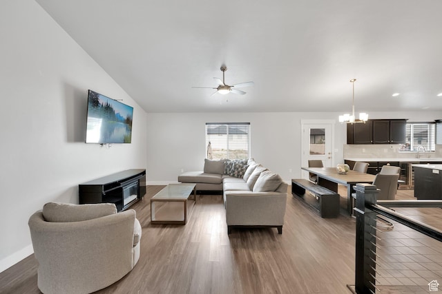 614 S Woodruff Way, Grantsville, UT 84029 - living room with wood finished floors, a wealth of natural light, baseboards, and ceiling fan with notable chandelier