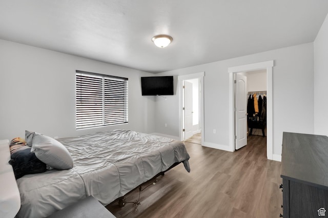 614 S Woodruff Way, Grantsville, UT 84029 - bedroom featuring light wood finished floors, ensuite bathroom, baseboards, a closet, and a walk in closet