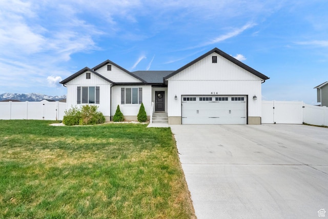 614 S Woodruff Way, Grantsville, UT 84029 - ranch-style house with a gate, concrete driveway, a front lawn, an attached garage, and fence