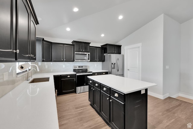 614 S Woodruff Way, Grantsville, UT 84029 - kitchen with stainless steel appliances, light countertops, dark cabinetry, a sink, and light wood-style floors