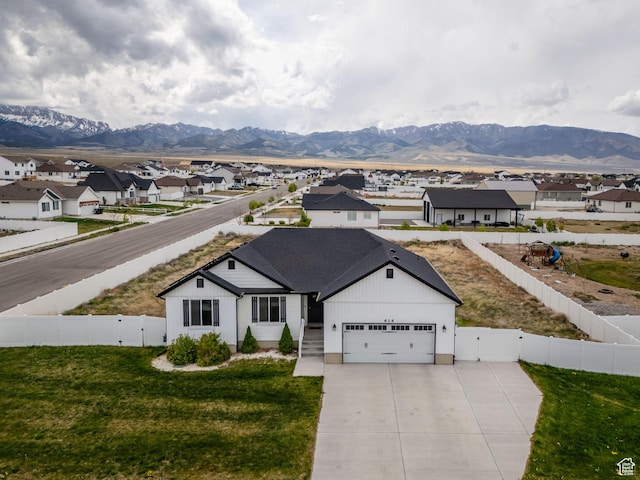 614 S Woodruff Way, Grantsville, UT 84029 - view of front of house featuring a residential view, a mountain view, concrete driveway, and a gate