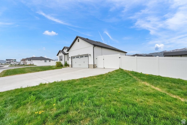 614 S Woodruff Way, Grantsville, UT 84029 - view of side of home with fence, a gate, a yard, and a garage