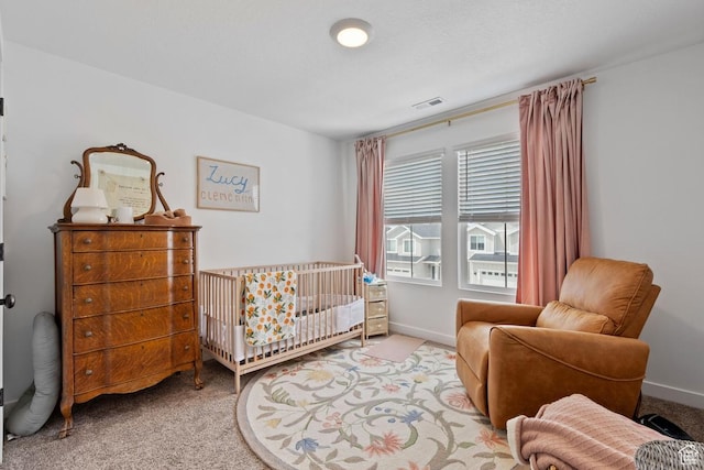 carpeted bedroom with baseboards and visible vents