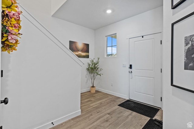 entryway with recessed lighting, baseboards, and light wood-type flooring