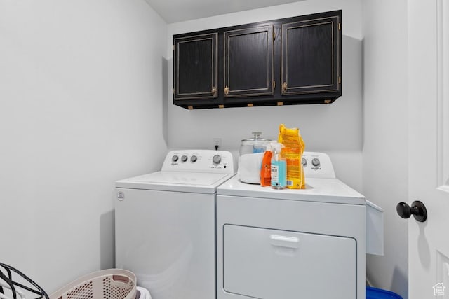 laundry area featuring washing machine and dryer and cabinet space