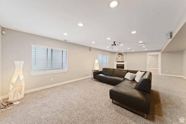 living area with baseboards, carpet, and recessed lighting
