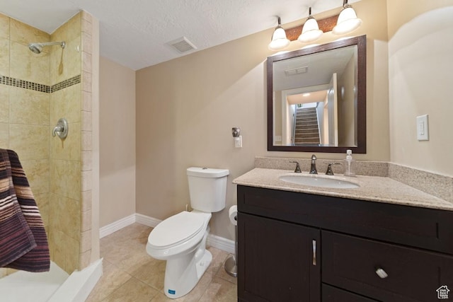 bathroom featuring a shower stall, vanity, baseboards, toilet, and visible vents
