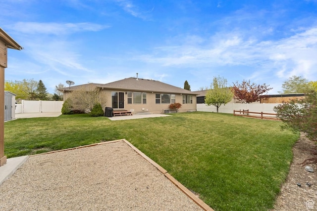 back of house with a patio area, a fenced backyard, a yard, and stucco siding