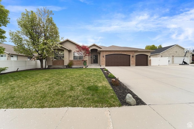 view of front facade with driveway, an attached garage, fence, a front yard, and brick siding