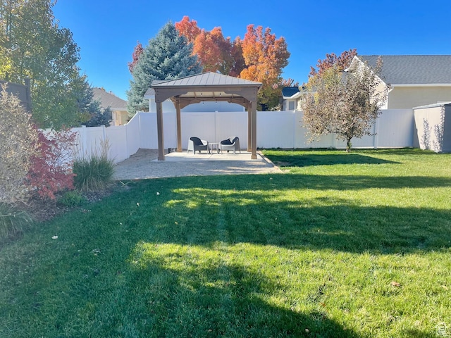 view of yard featuring a patio area, a fenced backyard, and a gazebo