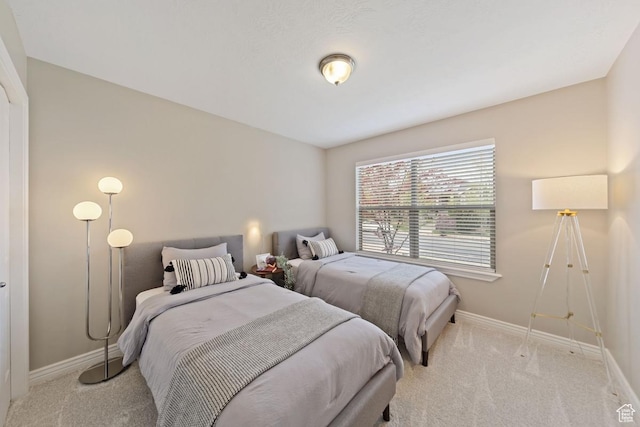 carpeted bedroom with baseboards