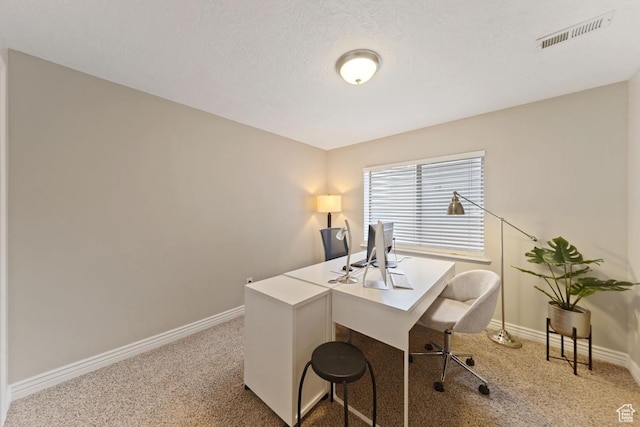 carpeted office with baseboards and visible vents
