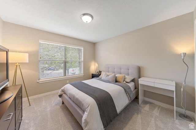 bedroom with carpet floors and baseboards