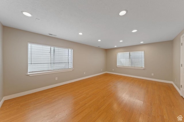 unfurnished room featuring visible vents, baseboards, recessed lighting, and light wood-style floors