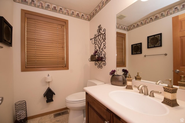 3090 N Rocky Rd E, Kamas, UT 84036 - bathroom with toilet, vanity, visible vents, and baseboards