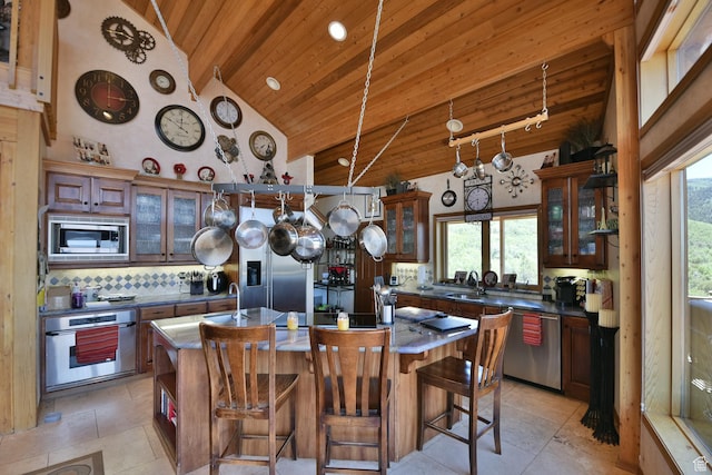 3090 N Rocky Rd E, Kamas, UT 84036 - kitchen featuring plenty of natural light, an island with sink, backsplash, wooden ceiling, and appliances with stainless steel finishes