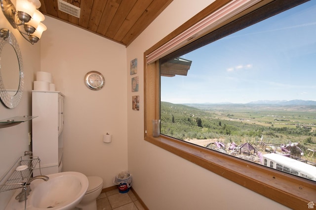 3090 N Rocky Rd E, Kamas, UT 84036 - bathroom with toilet, a mountain view, visible vents, tile patterned flooring, and wooden ceiling