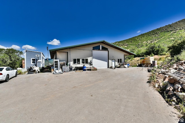3090 N Rocky Rd E, Kamas, UT 84036 - view of side of property featuring an outdoor structure, a mountain view, and a detached garage