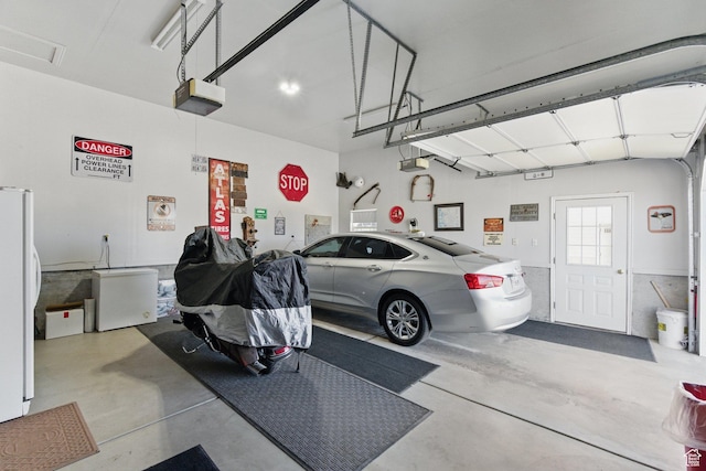 150 S Haulage Rd, Eureka, UT 84628 - garage with freestanding refrigerator and a garage door opener