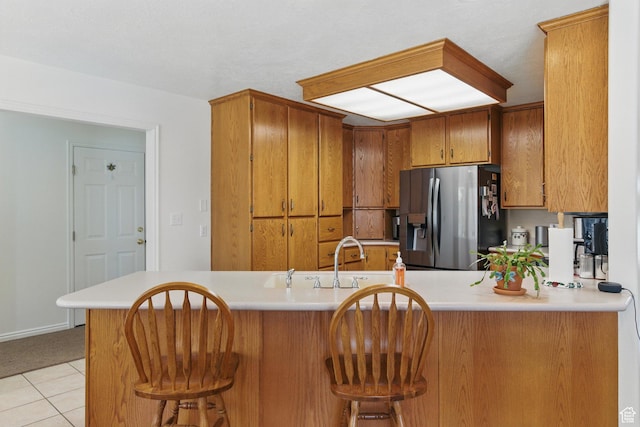 150 S Haulage Rd, Eureka, UT 84628 - kitchen with brown cabinets, light countertops, and stainless steel fridge with ice dispenser