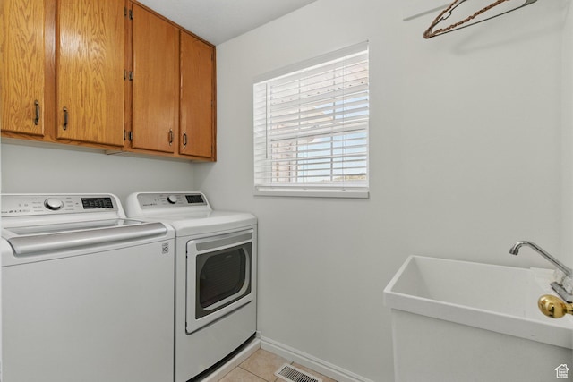 150 S Haulage Rd, Eureka, UT 84628 - clothes washing area featuring cabinet space, washing machine and clothes dryer, a sink, baseboards, and light tile patterned flooring