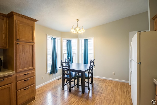 303 W 2000 S, Vernal, UT 84078 - dining area with a chandelier, a healthy amount of sunlight, and light wood-style floors