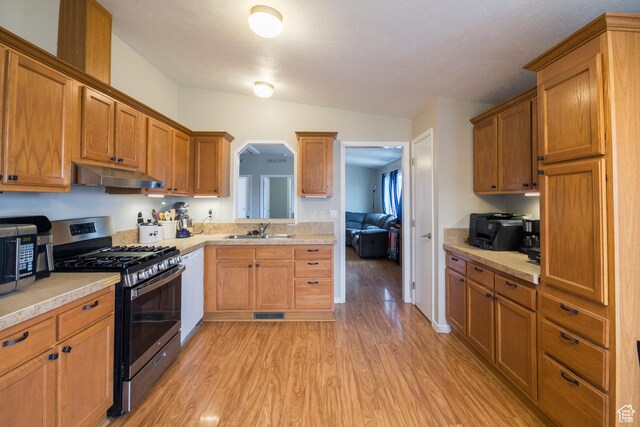 303 W 2000 S, Vernal, UT 84078 - kitchen with a sink, under cabinet range hood, light wood-style flooring, light countertops, and appliances with stainless steel finishes