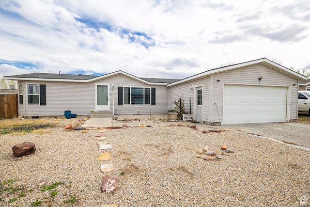 view of front of property with a garage, entry steps, and driveway