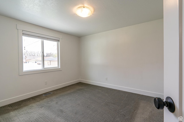 326 E 200 S, Logan, UT 84321 - spare room with baseboards, visible vents, dark colored carpet, and a textured ceiling