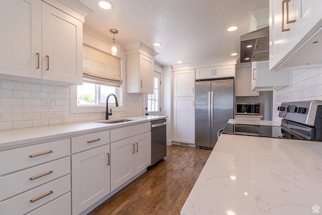 326 E 200 S, Logan, UT 84321 - kitchen featuring recessed lighting, decorative backsplash, appliances with stainless steel finishes, a sink, and white cabinetry