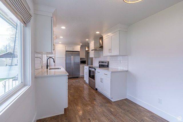326 E 200 S, Logan, UT 84321 - kitchen featuring tasteful backsplash, stainless steel appliances, white cabinets, a sink, and wall chimney exhaust hood