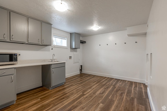 326 E 200 S, Logan, UT 84321 - kitchen with stainless steel microwave, a sink, dark wood-style flooring, gray cabinets, and a textured ceiling