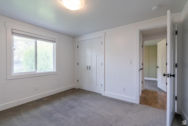 326 E 200 S, Logan, UT 84321 - unfurnished bedroom featuring baseboards, visible vents, and carpet