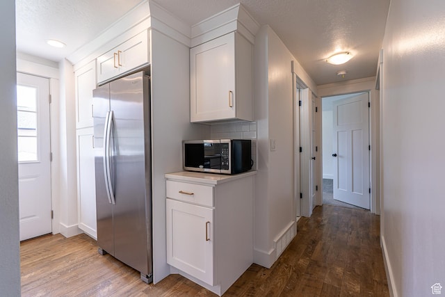 326 E 200 S, Logan, UT 84321 - kitchen with baseboards, stainless steel fridge, white cabinets, and light wood-type flooring
