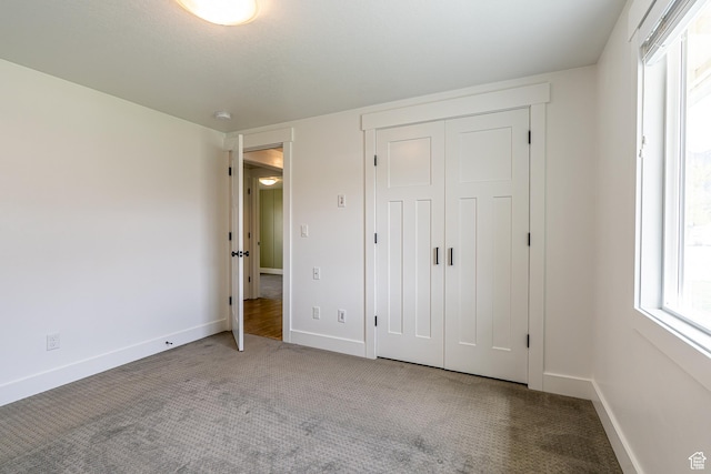 326 E 200 S, Logan, UT 84321 - unfurnished bedroom with a closet, carpet flooring, and baseboards