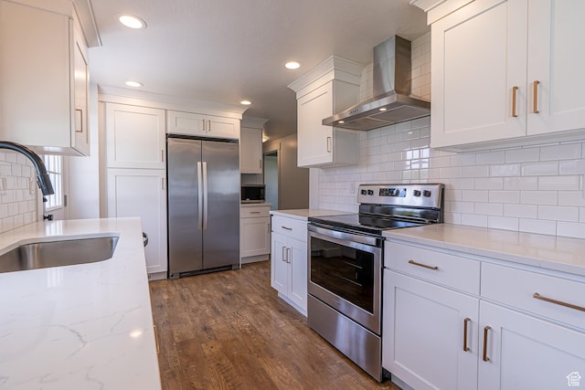 326 E 200 S, Logan, UT 84321 - kitchen featuring dark wood finished floors, decorative backsplash, stainless steel appliances, a sink, and wall chimney exhaust hood