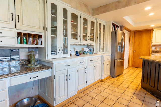 2548 E Cobblestone Way, Sandy, UT 84093 - kitchen featuring stainless steel refrigerator with ice dispenser, decorative backsplash, light tile patterned flooring, glass insert cabinets, and white cabinetry