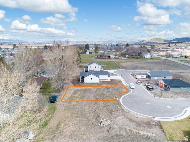 birds eye view of property with a mountain view