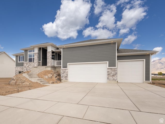2552 W 2950 N Unit 119, Farr West, UT 84404 - prairie-style home featuring a garage, a porch, driveway, and stone siding
