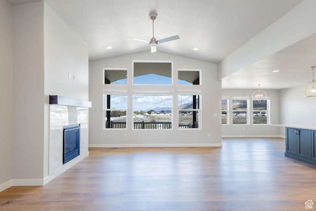 2552 W 2950 N Unit 119, Farr West, UT 84404 - unfurnished living room featuring a glass covered fireplace, light wood-style floors, baseboards, and ceiling fan with notable chandelier