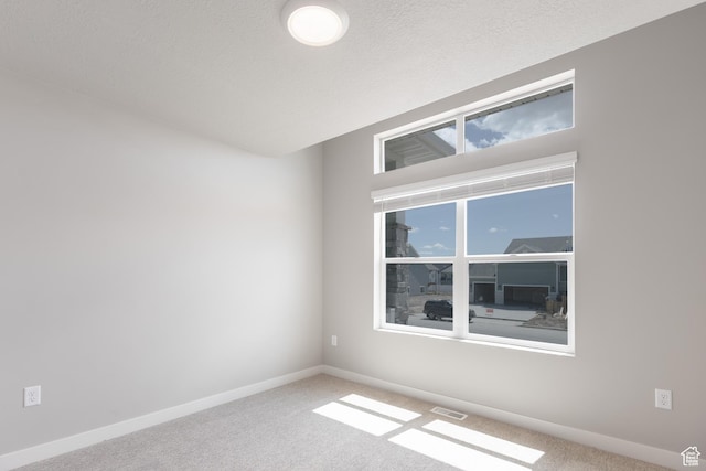 2552 W 2950 N Unit 119, Farr West, UT 84404 - spare room with baseboards, visible vents, and carpet flooring