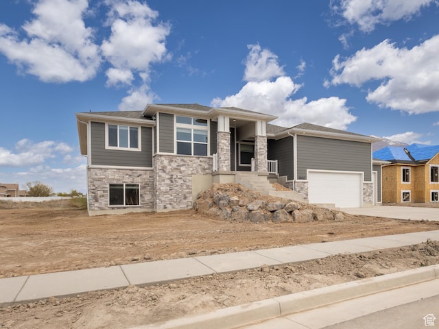 2552 W 2950 N Unit 119, Farr West, UT 84404 - prairie-style house featuring a garage, concrete driveway, and stone siding