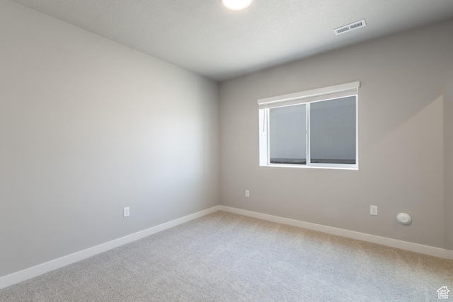 2552 W 2950 N Unit 119, Farr West, UT 84404 - empty room featuring baseboards, visible vents, and light colored carpet