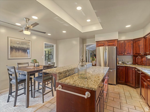 3131 E Alta Hills Dr S, Cottonwood Heights, UT 84093 - kitchen featuring a center island, freestanding refrigerator, ceiling fan, and light stone countertops