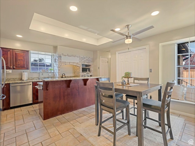 3131 E Alta Hills Dr S, Cottonwood Heights, UT 84093 - dining area with stone finish flooring, a ceiling fan, a tray ceiling, and recessed lighting