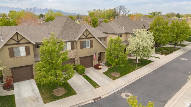 7170 S 420 E, Midvale, UT 84047 - view of front facade with a garage, a shingled roof, a residential view, driveway, and stucco siding