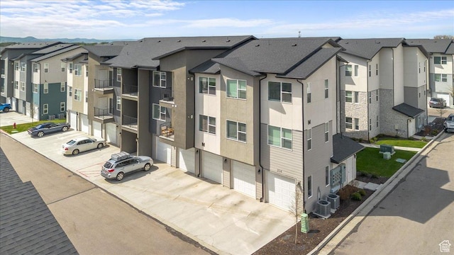 463 W 60 S Unit M204, Providence, UT 84332 - view of building exterior featuring a garage, a residential view, and driveway