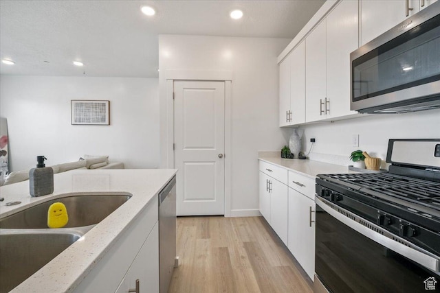 463 W 60 S Unit M204, Providence, UT 84332 - kitchen featuring white cabinetry, stainless steel appliances, recessed lighting, and light wood finished floors