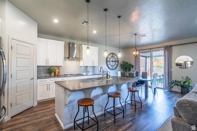 658 N Sage Crest Dr, Washington, UT 84780 - kitchen featuring visible vents, wall chimney exhaust hood, dark wood finished floors, and a sink
