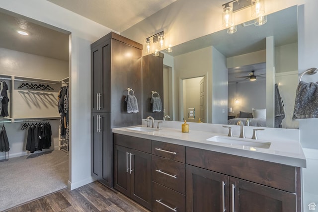 658 N Sage Crest Dr, Washington, UT 84780 - bathroom with double vanity, a sink, ceiling fan, and wood finished floors